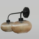 **Alt Text:** **2-Light Ribbed Glass** wall light with dual amber ribbed glass shades and a matte black metal frame, modern wall-mounted fixture for bedrooms, hallways, living rooms, and dining spaces.