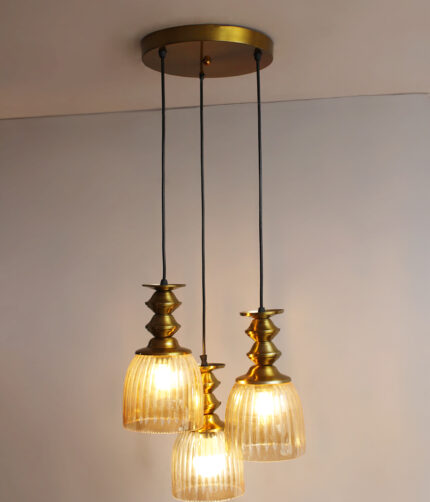 Ribbed Glass 3-Light adjustable pendant ceiling light with three textured glass shades, golden metal accents, black adjustable cords, 9-inch canopy, and elegant modern hanging design.