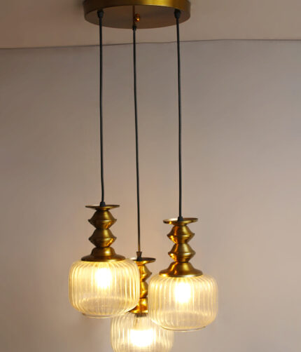 3-Light Ribbed Clear Glass adjustable pendant ceiling light with three 6-inch textured clear ribbed glass shades, decorative golden metal holders, black adjustable hanging cords, 9-inch circular canopy, and up to 23-inch adjustable height.