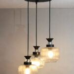 Clear Ribbed Glass cluster hanging light with three pendant shades, black metal fittings, and adjustable drops for modern dining room and living room interiors.