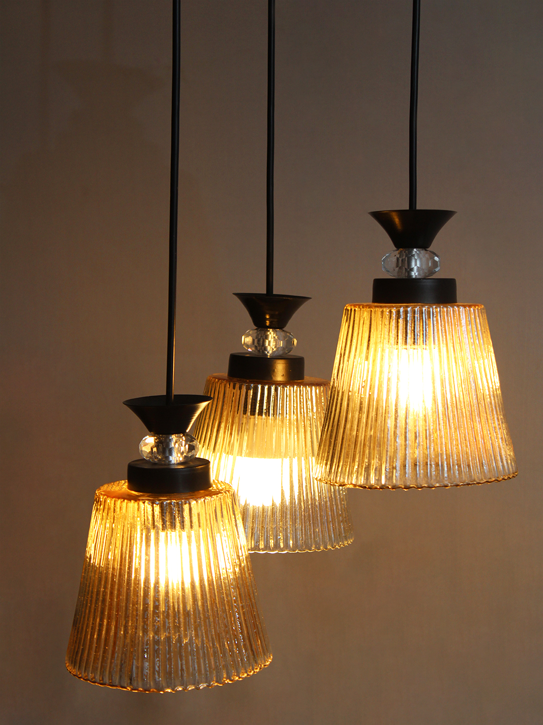 3-Light Ribbed Glass Cluster Hanging Light 3-Light Ribbed Glass cluster hanging light with three clear ribbed shades, adjustable 23-inch height and black ceiling canopy.