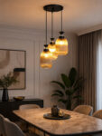 Decorative 3-Light cluster hanging light with three amber ribbed glass shades and black adjustable ceiling mount.
