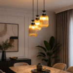 Decorative 3-Light cluster hanging light with three amber ribbed glass shades and black adjustable ceiling mount.