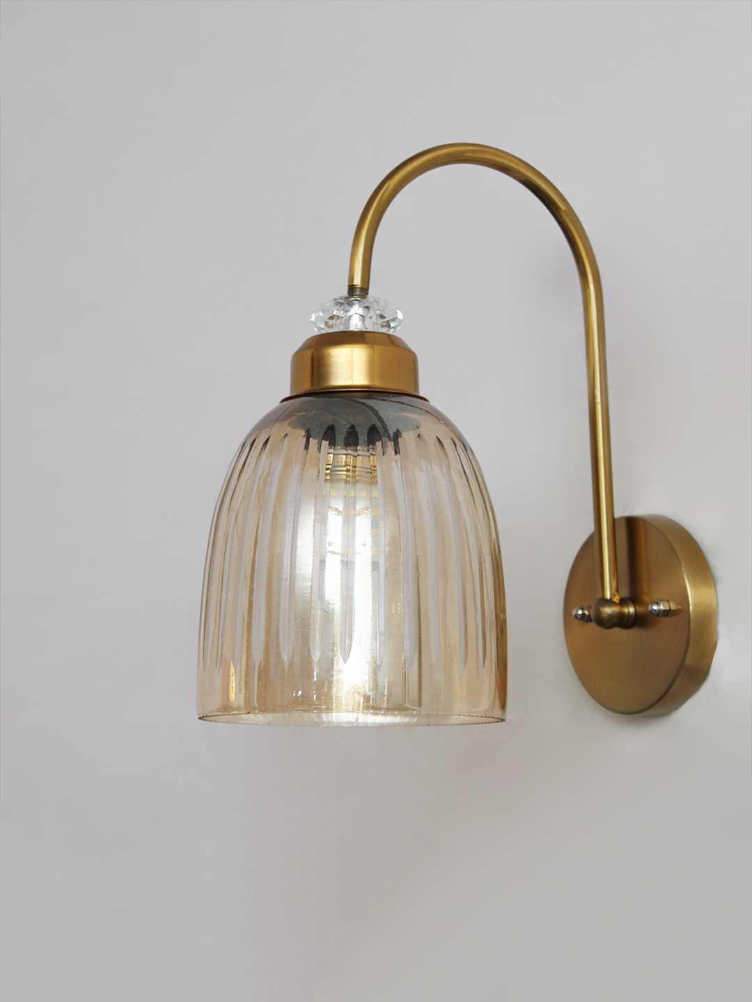 Antique Brass Amber Ribbed Glass Wall Light Antique brass wall light with amber ribbed glass shade and curved metal arm, shown with product dimensions.