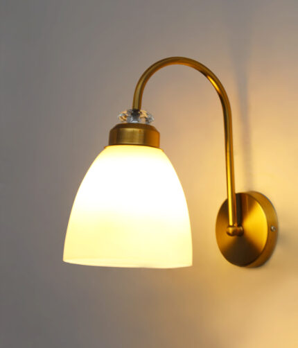 Antique brass frosted glass wall light with curved arm and white shade, 11-inch decorative wall lamp for bedroom and living room.