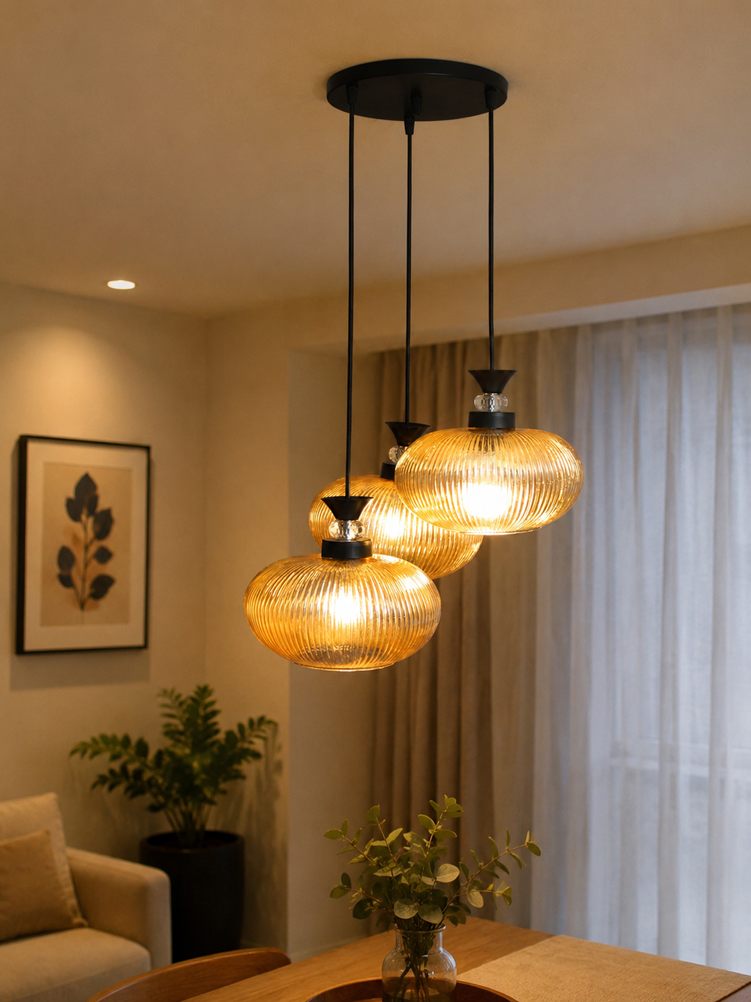 3-Light Amber Ribbed Glass Cluster Hanging Light Amber Ribbed Glass cluster hanging light with four textured glass pendant shades, black metal fittings, and layered design for modern interior lighting.