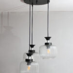 Clear Ribbed Glass cluster hanging light with three pendant shades, black metal fittings, and adjustable drops for modern dining room and living room interiors.