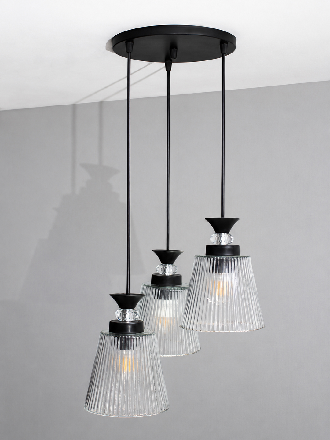 Modern Triple Glass Cluster Hanging Light Modern Triple Glass cluster hanging light with three clear ribbed glass shades and black metal ceiling mount.