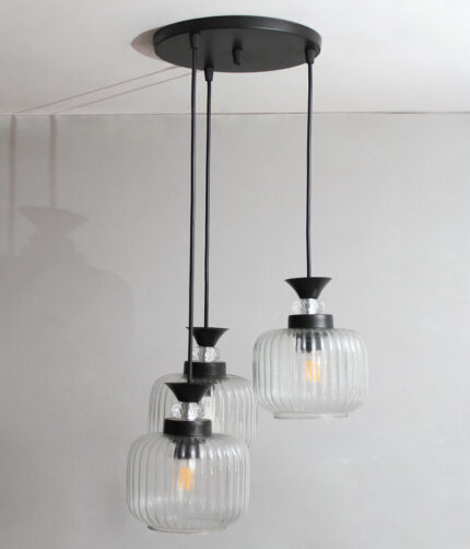 Clear Ribbed Glass cluster hanging light with three pendant shades, black metal fittings, and adjustable drops for modern dining room and living room interiors.