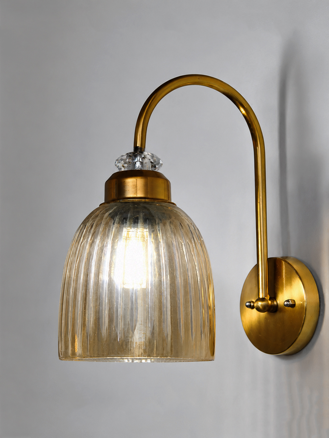 Antique Brass Amber Ribbed Glass Wall Light Antique brass wall light with amber ribbed glass shade and curved metal arm, shown with product dimensions.