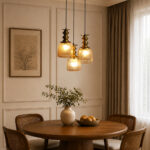 Ribbed Glass 3-Light adjustable pendant ceiling light with three textured glass shades, golden metal accents, black adjustable cords, 9-inch canopy, and elegant modern hanging design.