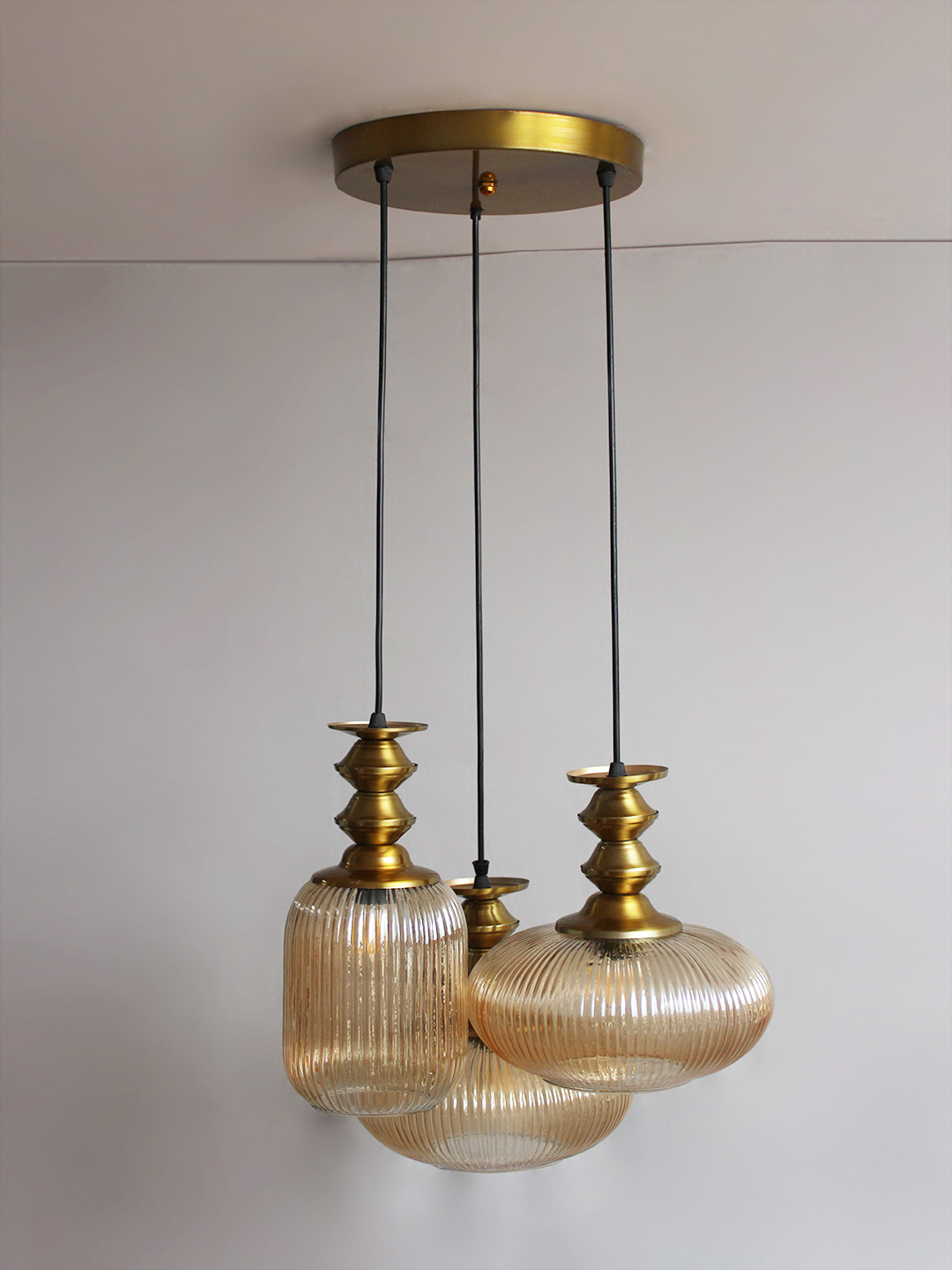 Modern Ribbed Glass Cluster Hanging Light Ribbed Modern Ribbed Glass 3-light adjustable pendant ceiling light featuring three textured ribbed glass shades in different shapes, elegant golden metal holders, black hanging cords, 9-inch canopy, and up to 23-inch adjustable height.