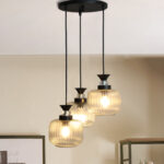 Clear Ribbed Glass cluster hanging light with three pendant shades, black metal fittings, and adjustable drops for modern dining room and living room interiors.