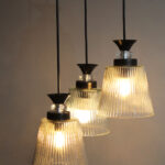 Modern Triple Glass cluster hanging light with three clear ribbed glass shades and black metal ceiling mount.