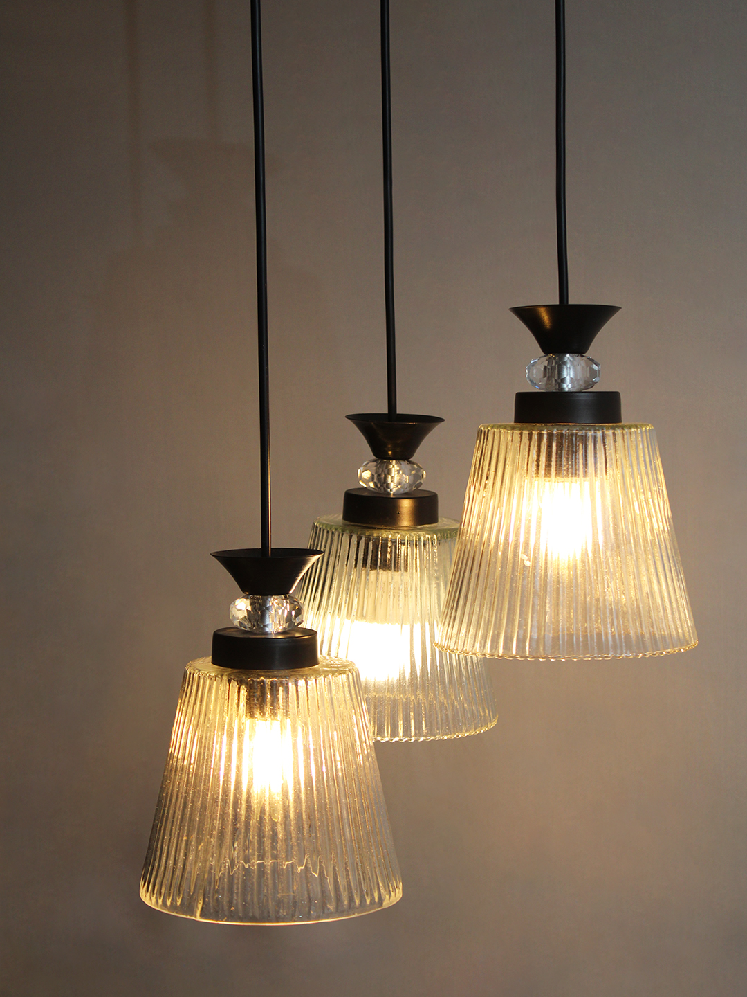 Modern Triple Glass Cluster Hanging Light Modern Triple Glass cluster hanging light with three clear ribbed glass shades and black metal ceiling mount.