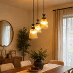 3-Light Ribbed Glass cluster hanging light with three clear ribbed shades, adjustable 23-inch height and black ceiling canopy.