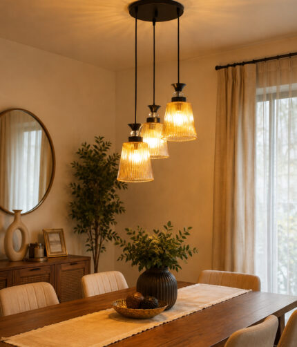 3-Light Ribbed Glass cluster hanging light with three clear ribbed shades, adjustable 23-inch height and black ceiling canopy.