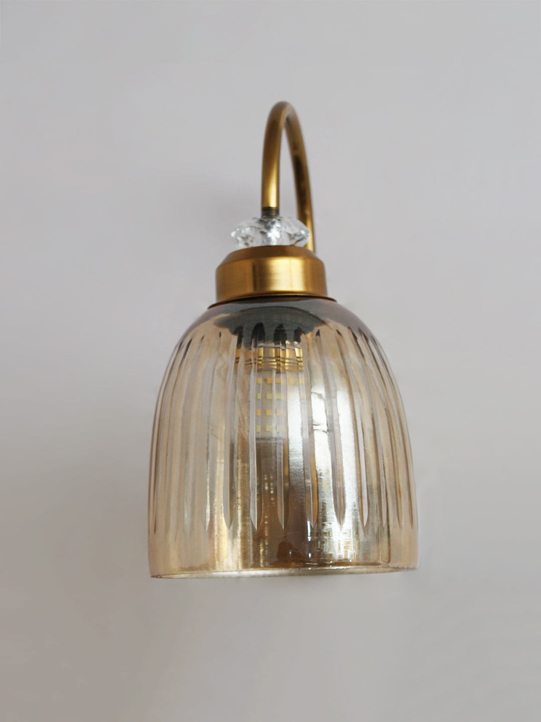 Antique Brass Amber Ribbed Glass Wall Light Antique brass wall light with amber ribbed glass shade and curved metal arm, shown with product dimensions.