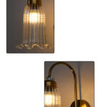 Antique brass fluted glass wall light with curved arm and decorative textured glass shade