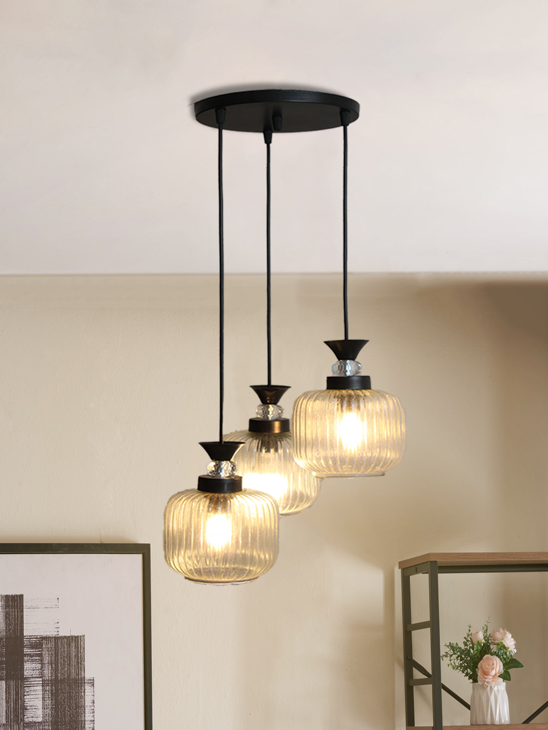 3-Light Clear Ribbed Glass Cluster Hanging Light Clear Ribbed Glass cluster hanging light with three pendant shades, black metal fittings, and adjustable drops for modern dining room and living room interiors.