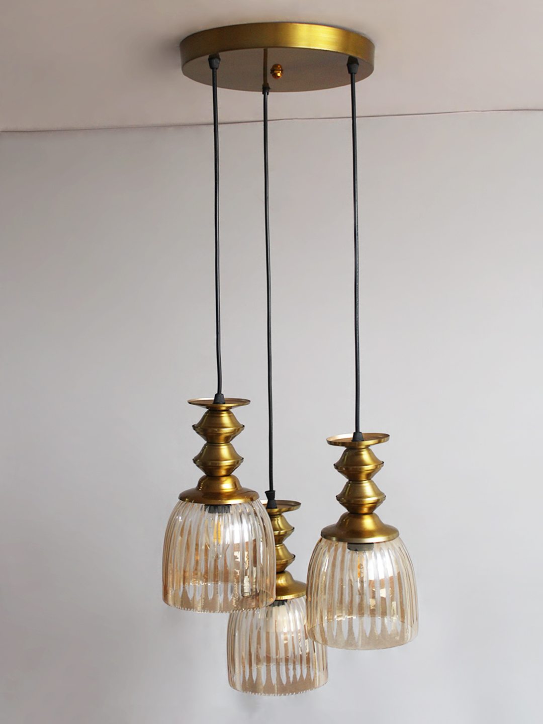 Ribbed Glass 3-Light Cluster Hanging Lamp Ribbed Glass 3-Light adjustable pendant ceiling light with three textured glass shades, golden metal accents, black adjustable cords, 9-inch canopy, and elegant modern hanging design.