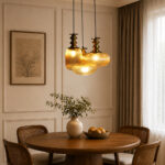 Ribbed Modern Ribbed Glass 3-light adjustable pendant ceiling light featuring three textured ribbed glass shades in different shapes, elegant golden metal holders, black hanging cords, 9-inch canopy, and up to 23-inch adjustable height.