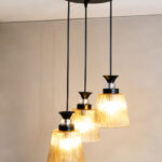 3-Light Ribbed Glass cluster hanging light with three clear ribbed shades, adjustable 23-inch height and black ceiling canopy.