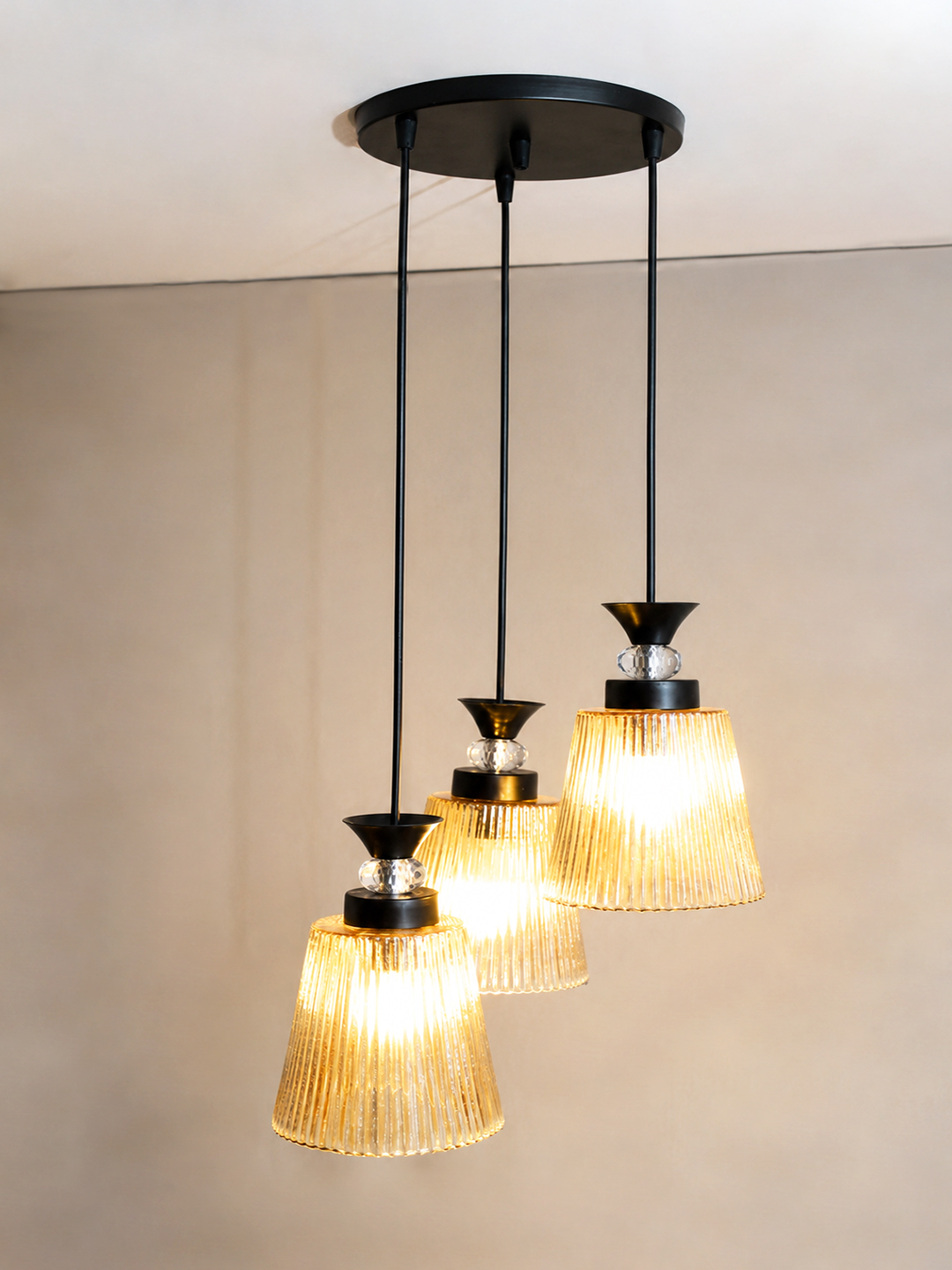 3-Light Ribbed Glass Cluster Hanging Light 3-Light Ribbed Glass cluster hanging light with three clear ribbed shades, adjustable 23-inch height and black ceiling canopy.