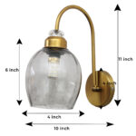 Antique brass smoked glass wall light with curved arm and round wall mount
