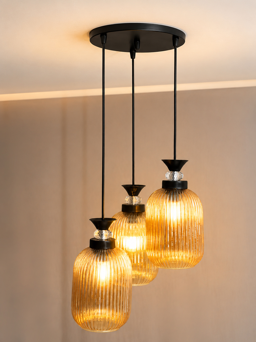 Decorative 3-Light Cluster Hanging Light Decorative 3-Light cluster hanging light with three amber ribbed glass shades and black adjustable ceiling mount.