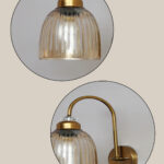 Antique brass wall light with amber ribbed glass shade and curved metal arm, shown with product dimensions.