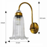 Antique brass fluted glass wall light with curved arm and decorative textured glass shade