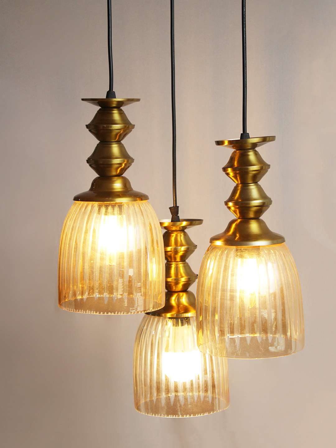 Ribbed Glass 3-Light Cluster Hanging Lamp Ribbed Glass 3-Light adjustable pendant ceiling light with three textured glass shades, golden metal accents, black adjustable cords, 9-inch canopy, and elegant modern hanging design.