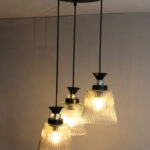 Modern Triple Glass cluster hanging light with three clear ribbed glass shades and black metal ceiling mount.