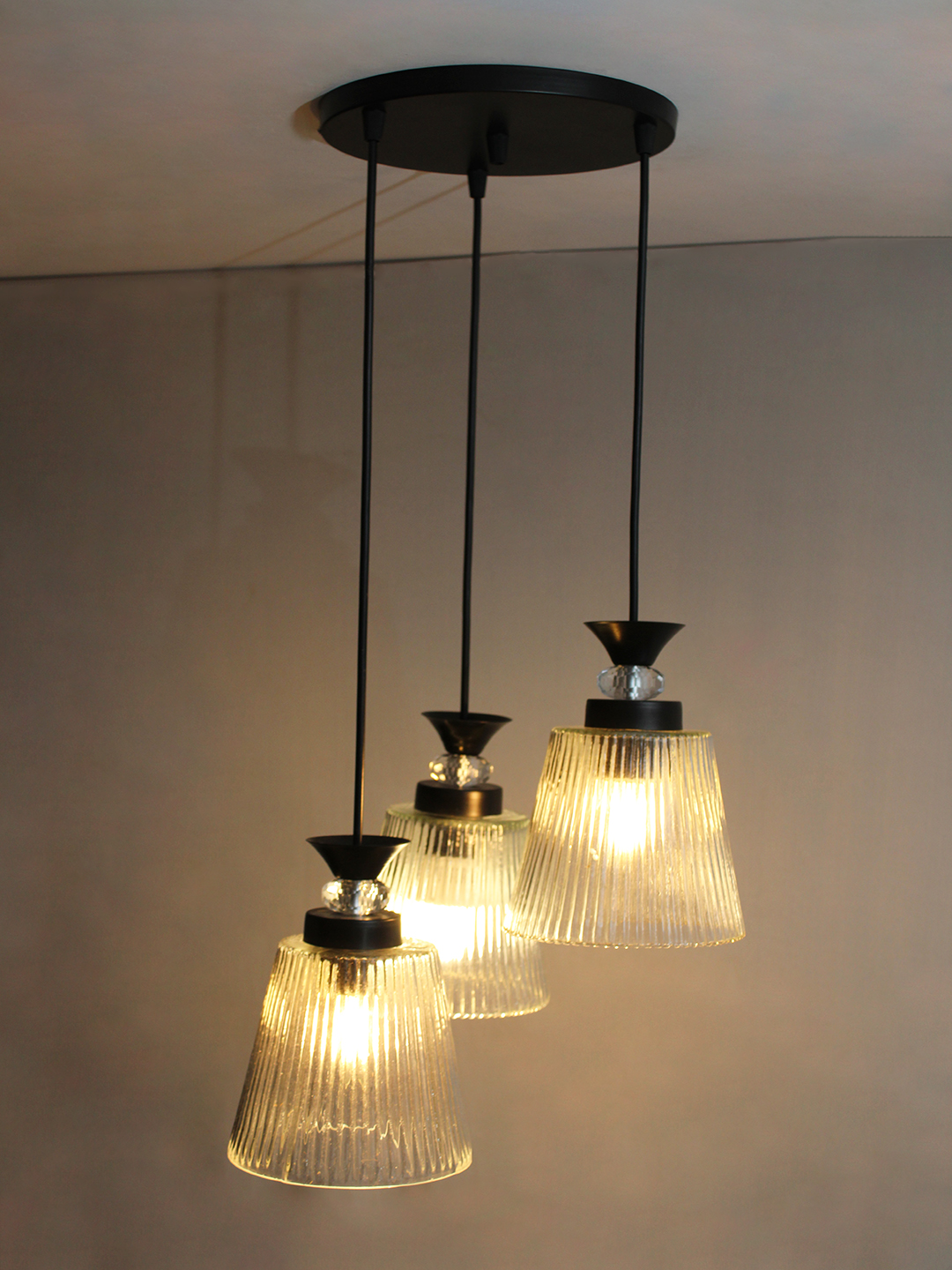 Modern Triple Glass Cluster Hanging Light Modern Triple Glass cluster hanging light with three clear ribbed glass shades and black metal ceiling mount.