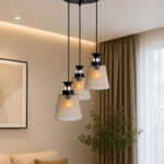 3-Light Ribbed Glass cluster hanging light with three clear ribbed shades, adjustable 23-inch height and black ceiling canopy.