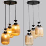 Decorative 3-Light cluster hanging light with three amber ribbed glass shades and black adjustable ceiling mount.