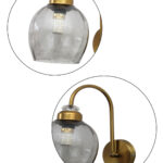 Antique brass smoked glass wall light with curved arm and round wall mount