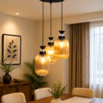 Decorative 3-Light cluster hanging light with three amber ribbed glass shades and black adjustable ceiling mount.