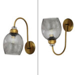 Antique brass smoked glass wall light with curved arm and round wall mount