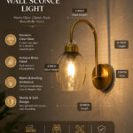 Antique brass smoked glass wall light with curved arm and round wall mount