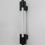 Black vertical LED wall light with multiple white diffusers and slim modern design