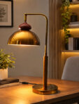 Gold Brass Table Lamp with vintage dome shade, curved brass arm, and round base, 15 inches tall with an 8-inch shade.