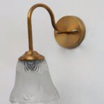 Flower Glass Wall Lamp with antique brass finish and decorative clear floral glass shade.