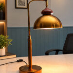 Gold Brass Table Lamp with vintage dome shade, curved brass arm, and round base, 15 inches tall with an 8-inch shade.