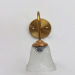 Flower Glass Wall Lamp with antique brass finish and decorative clear floral glass shade.