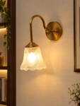 Flower Glass Wall Lamp with antique brass finish and decorative clear floral glass shade.