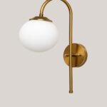 Gold finish wall light with Round White Glass globe and curved arm for modern home decor