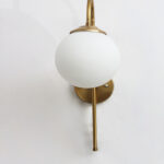 Gold finish wall light with Round White Glass globe and curved arm for modern home decor