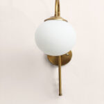 Gold finish wall light with Round White Glass globe and curved arm for modern home decor